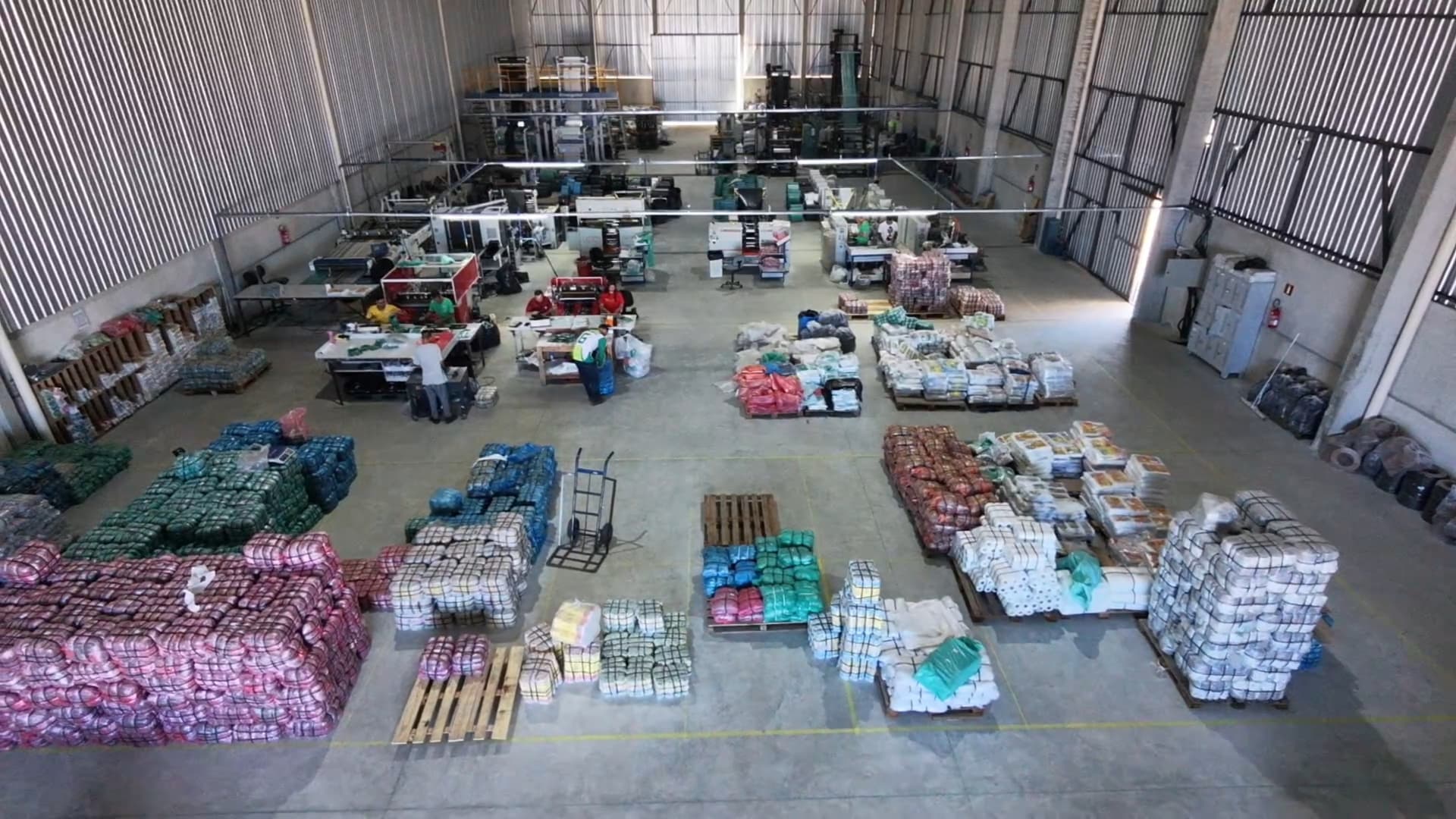 Vista interna da produção Feliz com maquinário moderno e equipe trabalhando